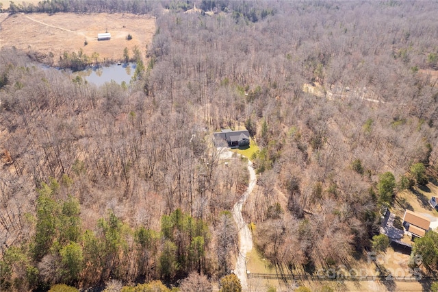 birds eye view of property featuring a water view and a forest view