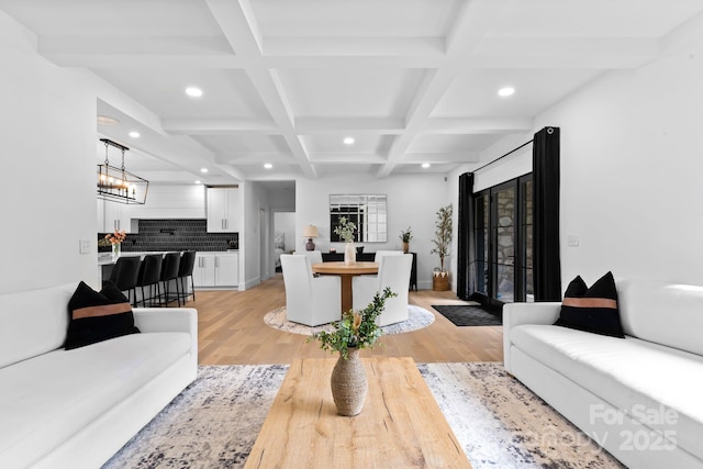 living room with light wood-style floors, recessed lighting, and beamed ceiling