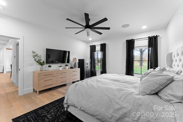 bedroom featuring ceiling fan, light wood finished floors, recessed lighting, and baseboards