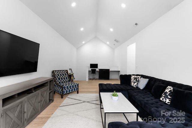 living room with visible vents, high vaulted ceiling, light wood-style flooring, and recessed lighting