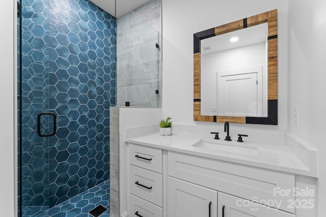 bathroom featuring a shower stall, visible vents, and vanity