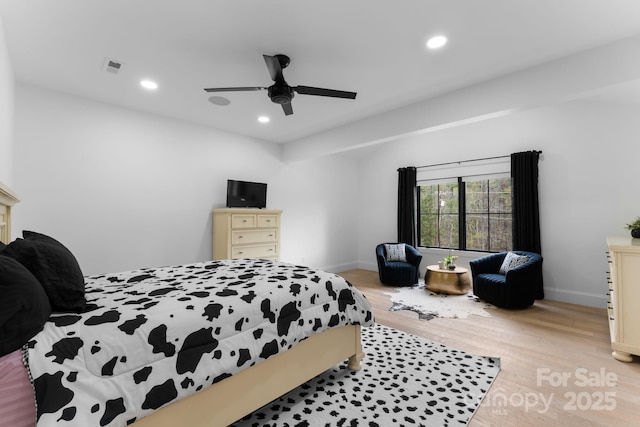 bedroom featuring visible vents, baseboards, light wood-style flooring, and recessed lighting