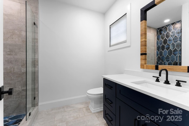 full bathroom featuring baseboards, toilet, tile patterned floors, vanity, and a shower stall