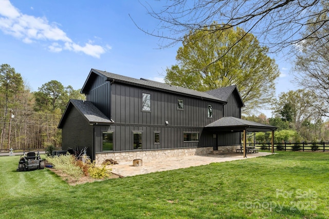 back of house with a patio, fence, roof with shingles, a lawn, and board and batten siding