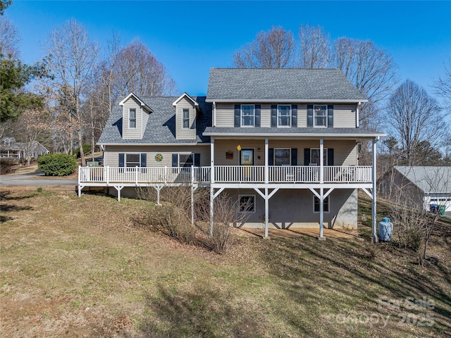 view of front of house featuring roof with shingles and a front lawn