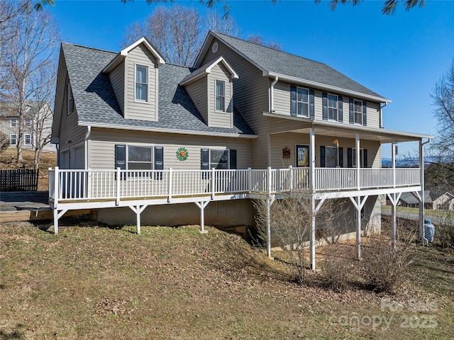 view of front of property featuring a garage and a shingled roof