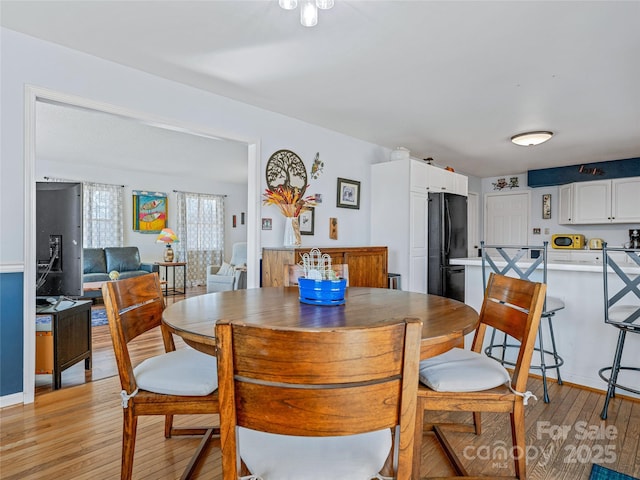 dining space with light wood finished floors