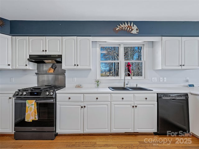 kitchen with stainless steel range with gas cooktop, white cabinetry, a sink, dishwasher, and under cabinet range hood