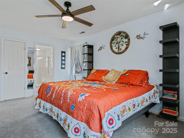 bedroom with ensuite bath, carpet, and a ceiling fan