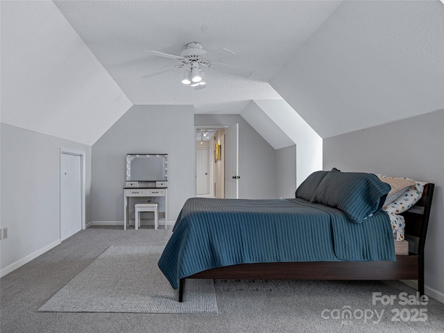 bedroom featuring ceiling fan, a textured ceiling, baseboards, vaulted ceiling, and carpet