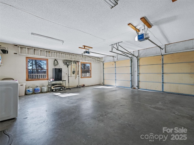 garage featuring washer / clothes dryer and a garage door opener