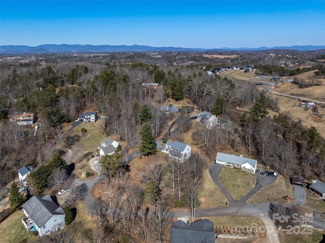 bird's eye view with a mountain view and a forest view