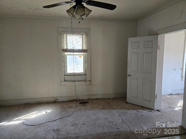 spare room featuring ceiling fan and crown molding