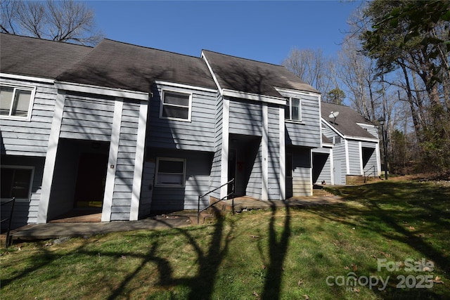 rear view of house featuring a yard