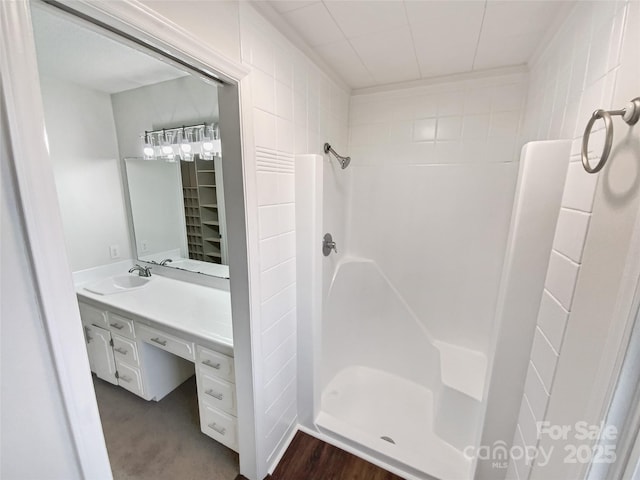 full bath with wood finished floors, a shower stall, and vanity