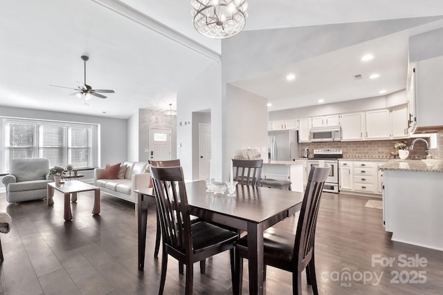 dining area with ceiling fan with notable chandelier, dark wood finished floors, visible vents, and recessed lighting