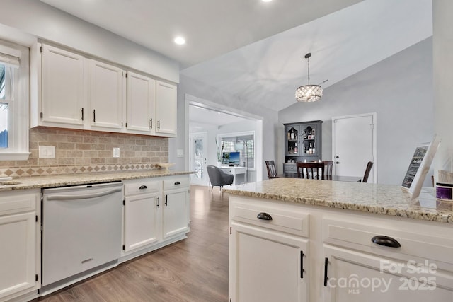 kitchen with light wood finished floors, tasteful backsplash, lofted ceiling, white cabinetry, and white dishwasher