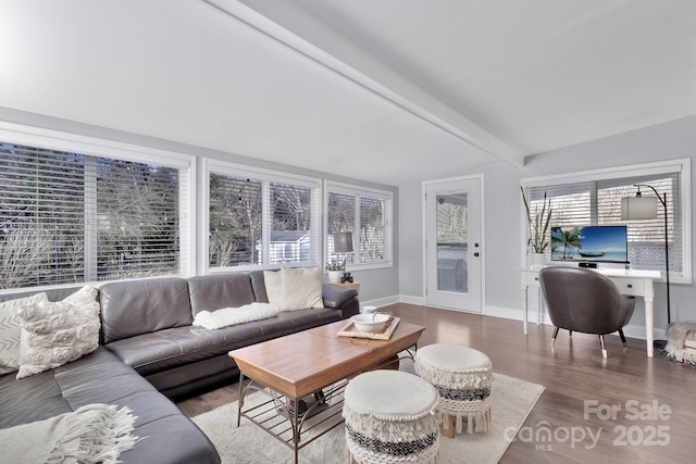 living room featuring vaulted ceiling with beams, baseboards, and wood finished floors