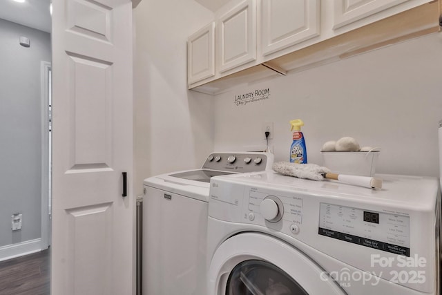 clothes washing area with dark wood-style flooring, cabinet space, baseboards, and separate washer and dryer