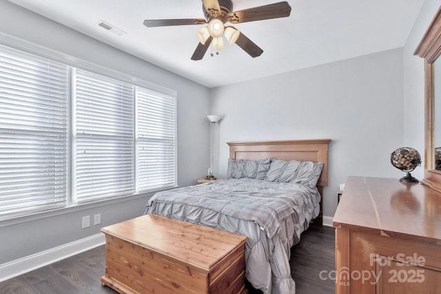 bedroom with ceiling fan, dark wood-type flooring, visible vents, and baseboards