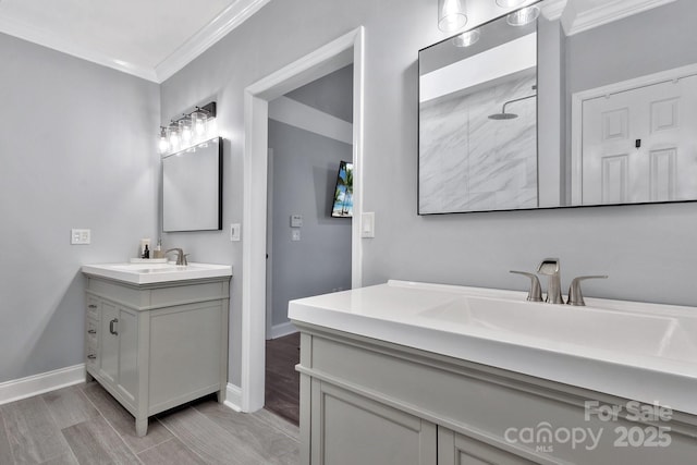 bathroom with baseboards, two vanities, a sink, and crown molding