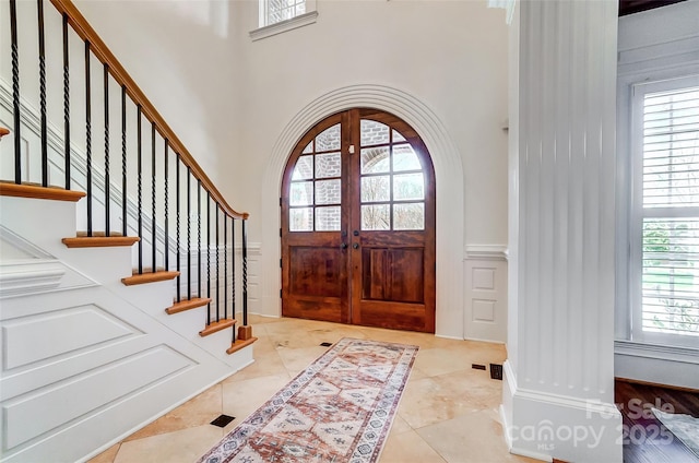 6548 Robin Hollow Dr, Mint Hill, NC 28227 - tiled entryway with arched walkways, a decorative wall, and stairs