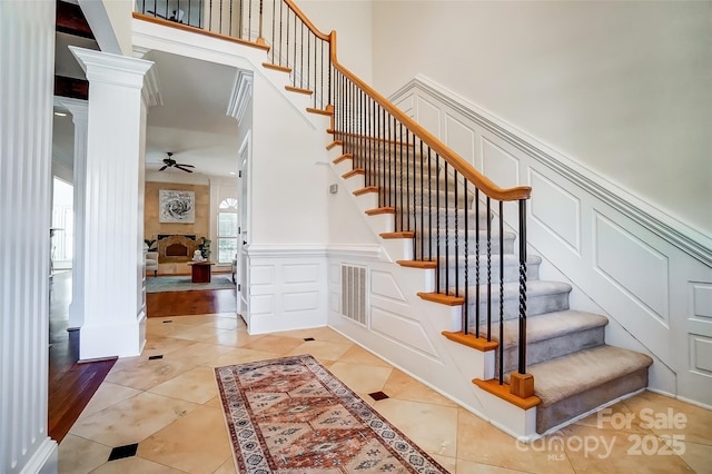 6548 Robin Hollow Dr, Mint Hill, NC 28227 - stairs featuring visible vents, ornate columns, ceiling fan, tile patterned floors, and a decorative wall