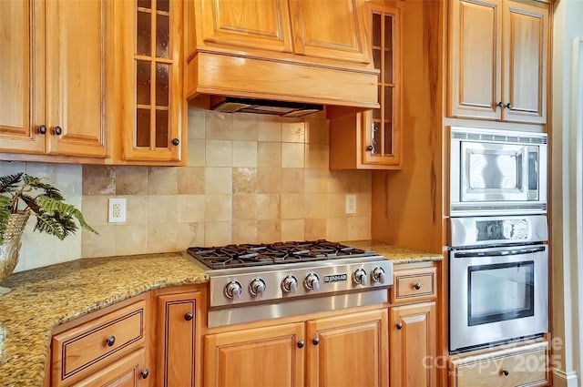 6548 Robin Hollow Dr, Mint Hill, NC 28227 - kitchen featuring a warming drawer, custom range hood, light stone counters, tasteful backsplash, and appliances with stainless steel finishes
