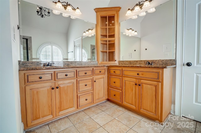 6548 Robin Hollow Dr, Mint Hill, NC 28227 - bathroom with double vanity, a sink, vaulted ceiling, and tile patterned flooring
