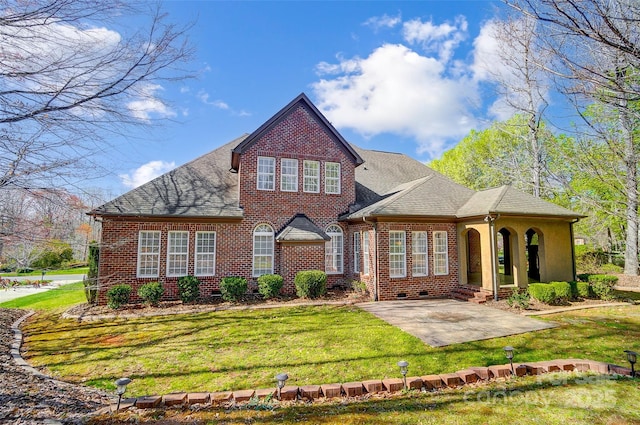 6548 Robin Hollow Dr, Mint Hill, NC 28227 - view of front of home with brick siding, a patio area, a shingled roof, and a front yard