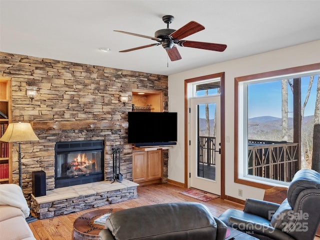 61 Creekside Way Unit G201, Burnsville, NC 28714 - living area featuring wood finished floors, baseboards, ceiling fan, and a fireplace