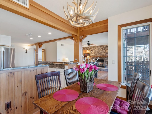 61 Creekside Way Unit G201, Burnsville, NC 28714 - dining area featuring a chandelier, recessed lighting, a stone fireplace, a ceiling fan, and wood finished floors