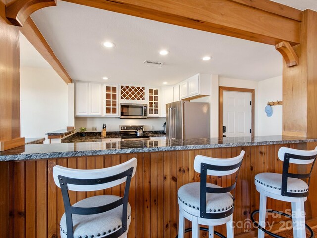 61 Creekside Way Unit G201, Burnsville, NC 28714 - kitchen featuring appliances with stainless steel finishes, glass insert cabinets, white cabinetry, recessed lighting, and a peninsula