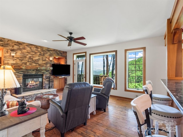 61 Creekside Way Unit G201, Burnsville, NC 28714 - living area with plenty of natural light, hardwood / wood-style floors, ceiling fan, and a stone fireplace