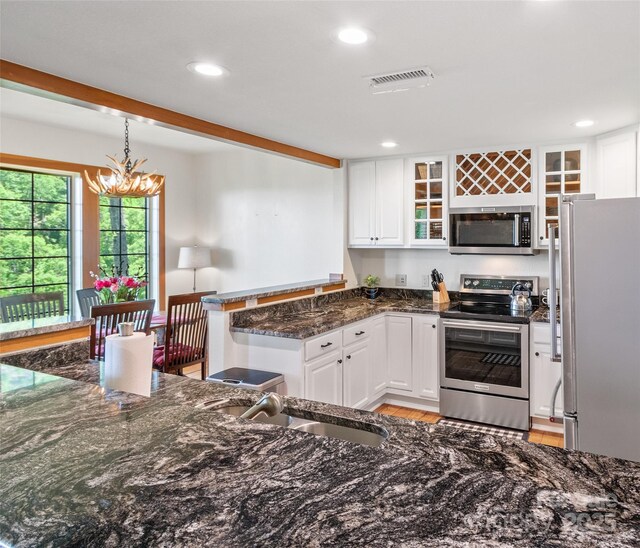61 Creekside Way Unit G201, Burnsville, NC 28714 - kitchen with appliances with stainless steel finishes, a sink, white cabinetry, a peninsula, and recessed lighting