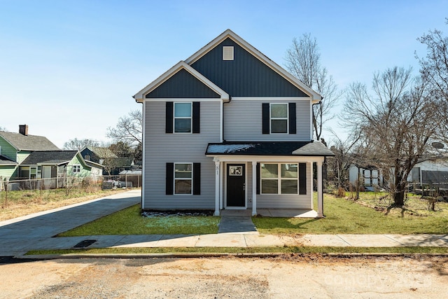 view of front of house with a front lawn and fence