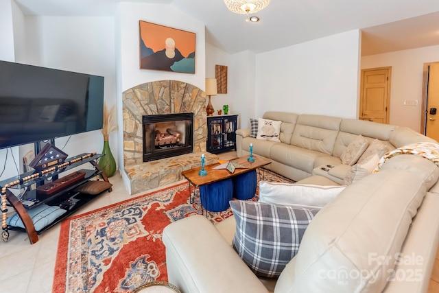 tiled living area with lofted ceiling and a stone fireplace