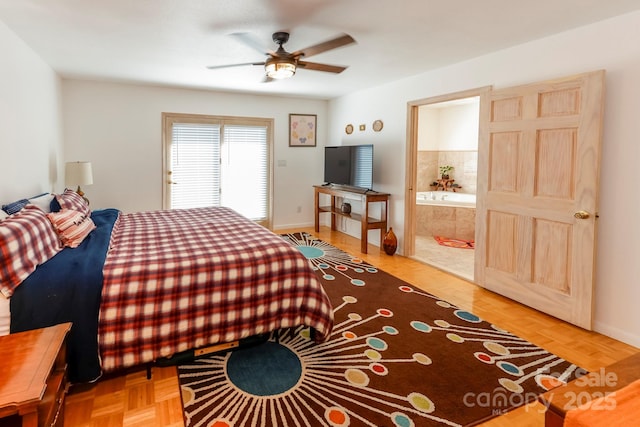 bedroom featuring a ceiling fan, baseboards, and ensuite bath