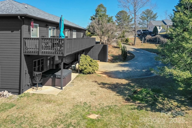 view of yard with a deck and a patio