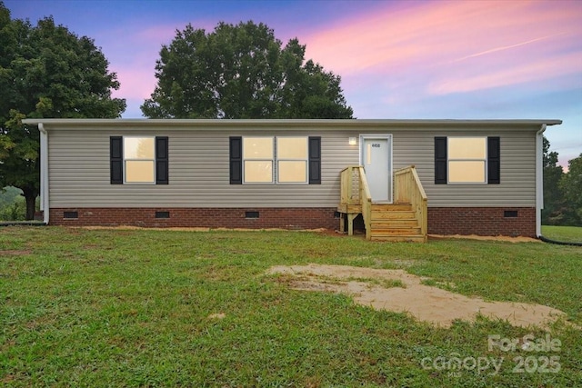 manufactured / mobile home with crawl space and a yard