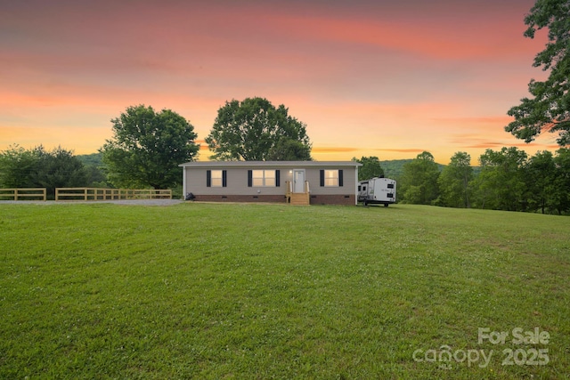 manufactured / mobile home with crawl space, fence, and a front yard