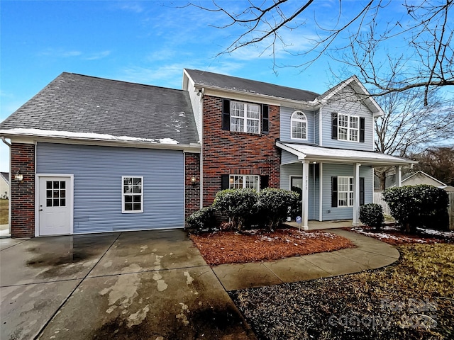 view of front facade featuring covered porch and brick siding