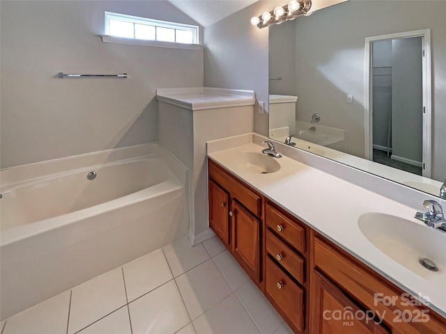 bathroom featuring double vanity, tile patterned flooring, vaulted ceiling, and a sink