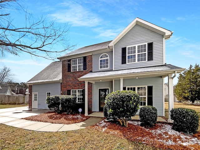 traditional-style house featuring covered porch