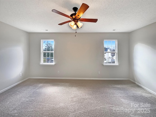 spare room with ceiling fan, a textured ceiling, carpet, and baseboards