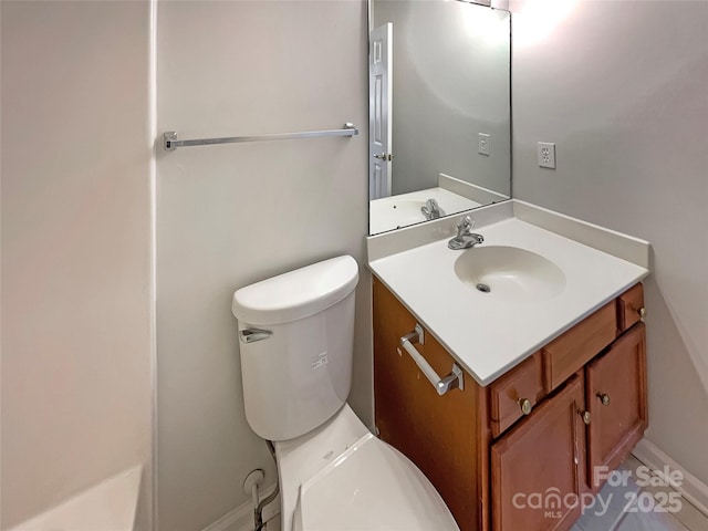 bathroom featuring toilet and vanity