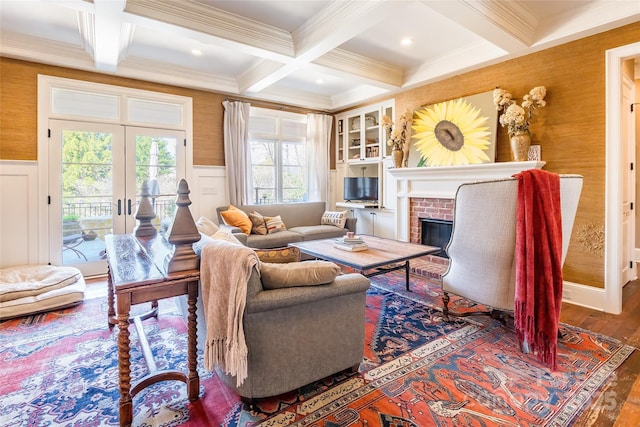 living room with beam ceiling, coffered ceiling, and a brick fireplace