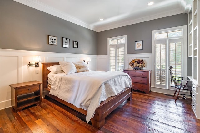 bedroom with access to exterior, crown molding, wood-type flooring, and wainscoting