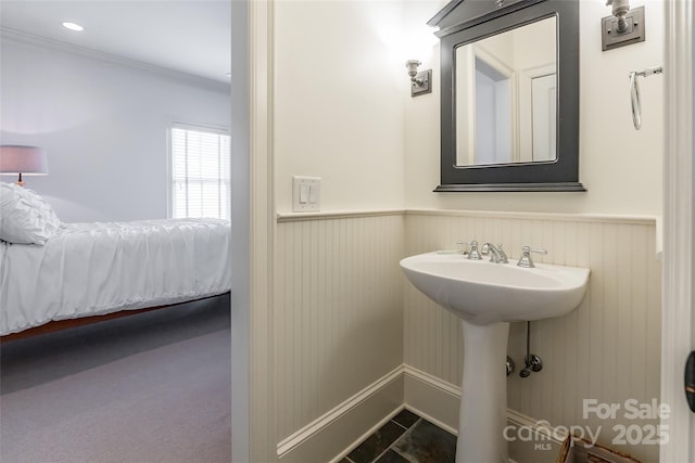 bathroom with a wainscoted wall, recessed lighting, and crown molding