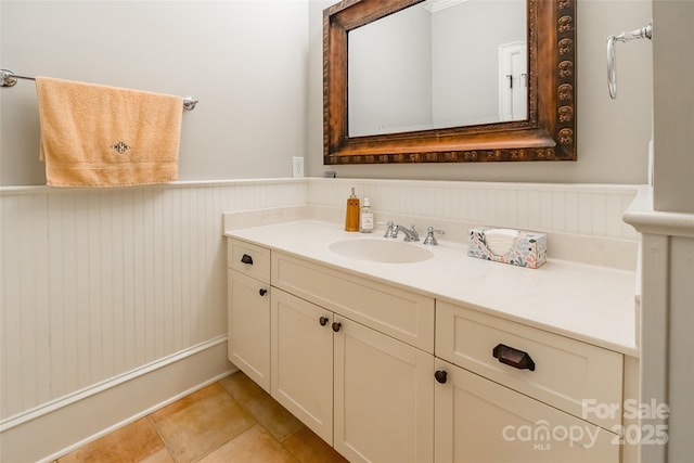 bathroom featuring tile patterned floors, vanity, and wainscoting